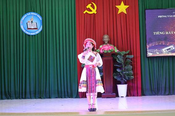 'A child on stage with a microphoneAI-generated content may be incorrect.'