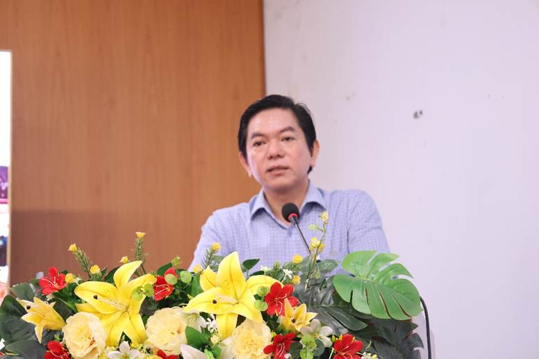 '''A person standing at a podium with flowers

AI-generated content may be incorrect.'''